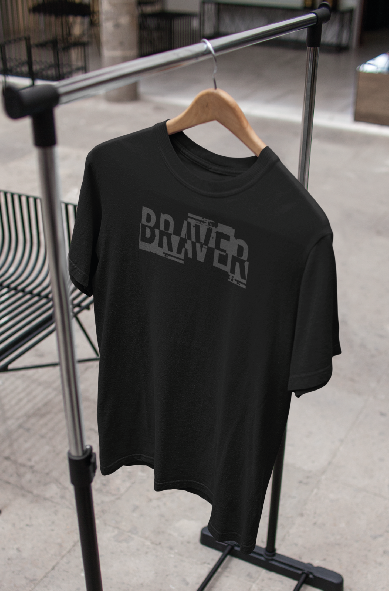 Black unisex tshirt with the word BRAVER printed on the chest in colour grey