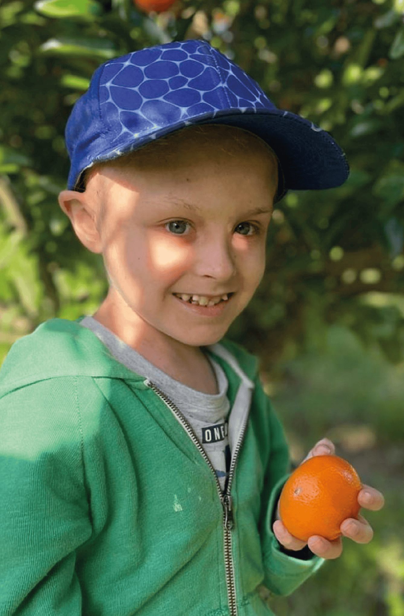 Headshot of Hunter with an orange