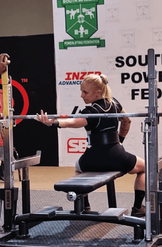 Powerlifting athlete setting up to bench press at South African Nationals