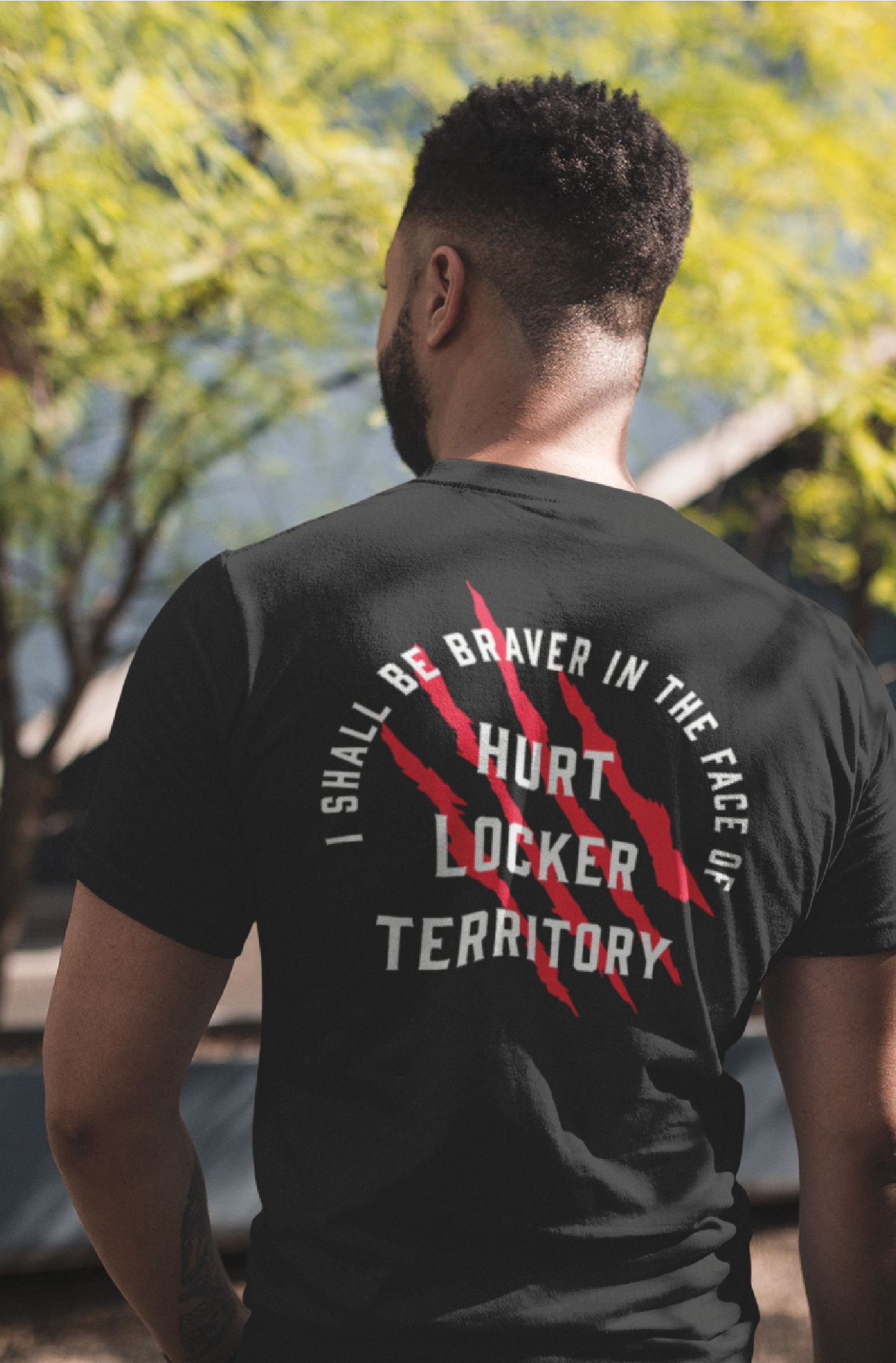 Back of a unisex black t-shirt with a typographic print in red and white