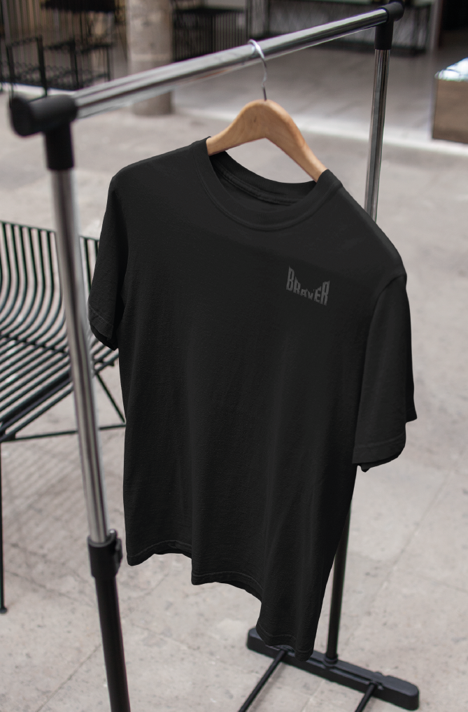 Black T-shirt with grey pocket print  hanging on a clothing rail