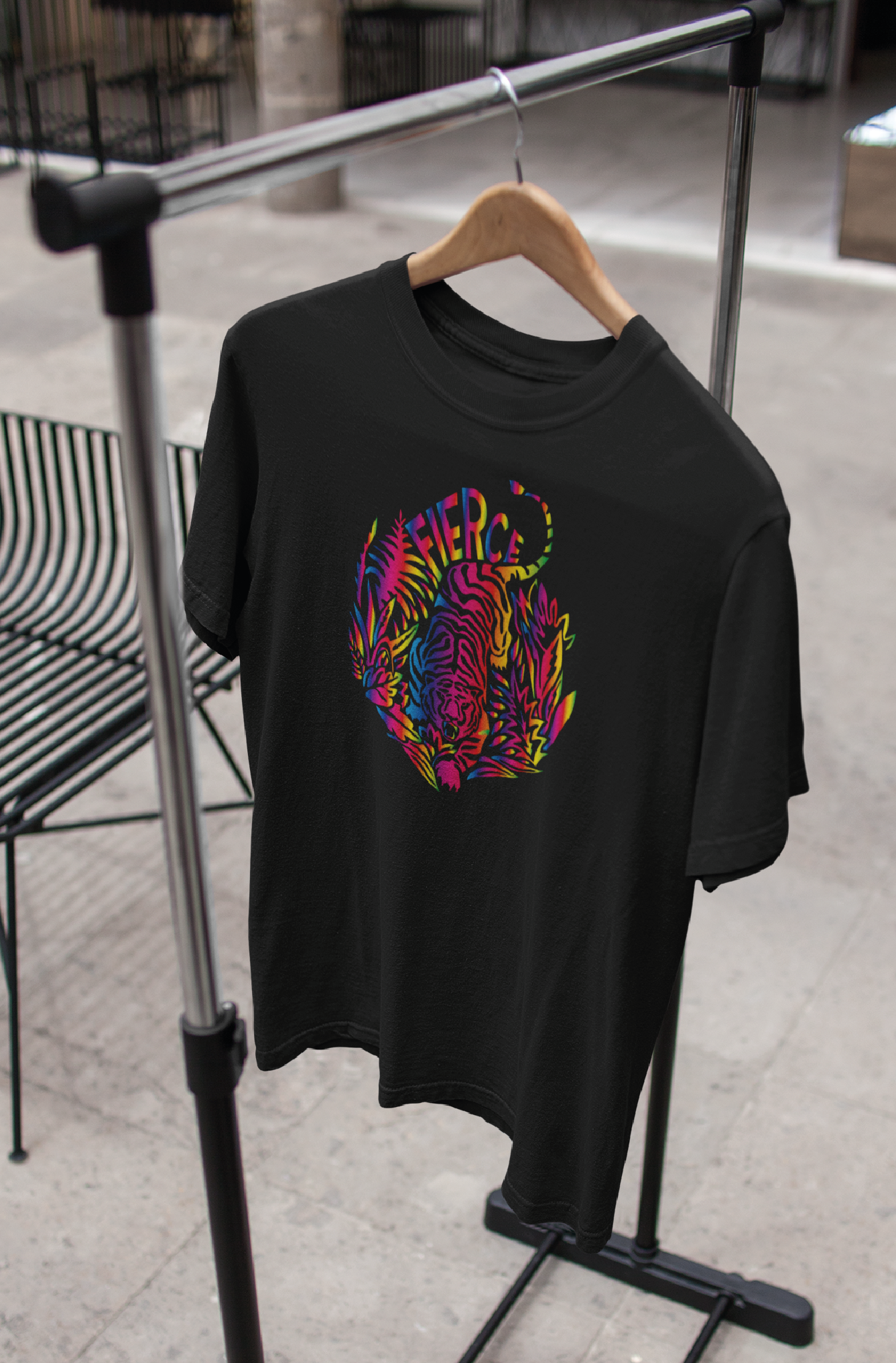 Black unisex t-shirt with tiger rainbow print hanging on a rail