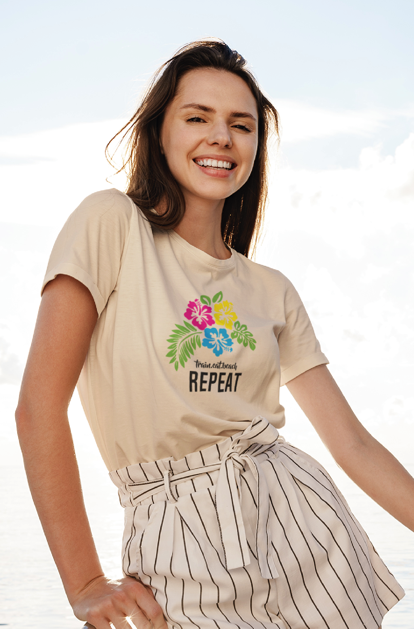 Women out on a boat smiling wearing a white tshirt with neon hibiscus flowers and typographic elements on