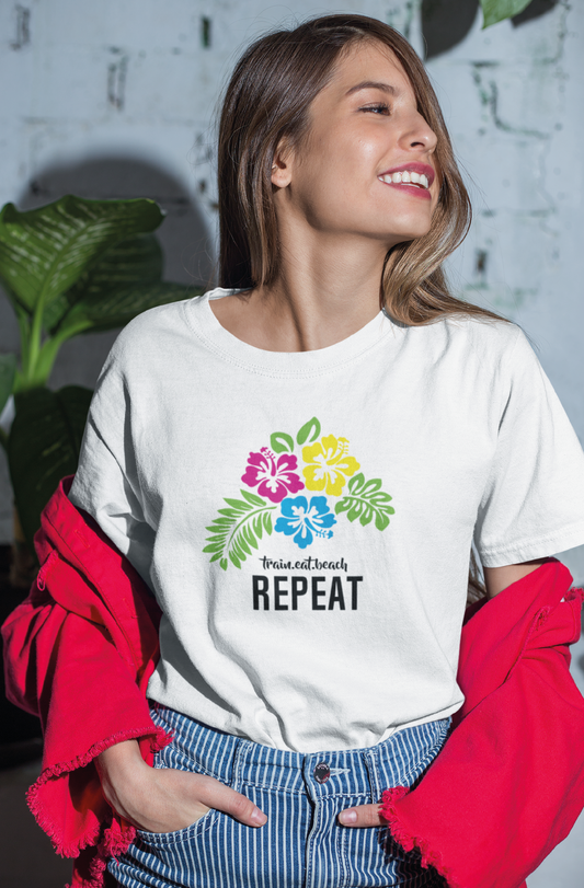 Women smiling wearing a white tshirt with neon hibiscus flowers and typographic elements on